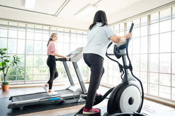 Asian cute lady jogging or exercise, workout on running machine or treadmill, her looking and...