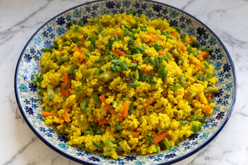 Millet and Vegetable Stir-Fry dish on marble table.