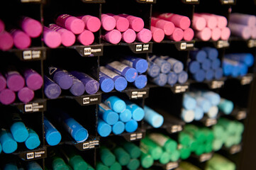 Selective focus on bright colorful pastel pencils and crayons in cool colors, displayed for sale on...