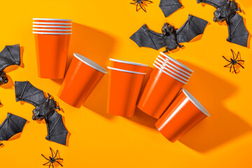 Halloween party background with Paper cup with spiders, bats. Disposable cup made of recycled paper...