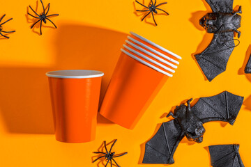 Halloween party background with Paper cup with spiders, bats. Disposable cup made of recycled paper...