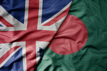 big waving national colorful flag of great britain and national flag of bangladesh .