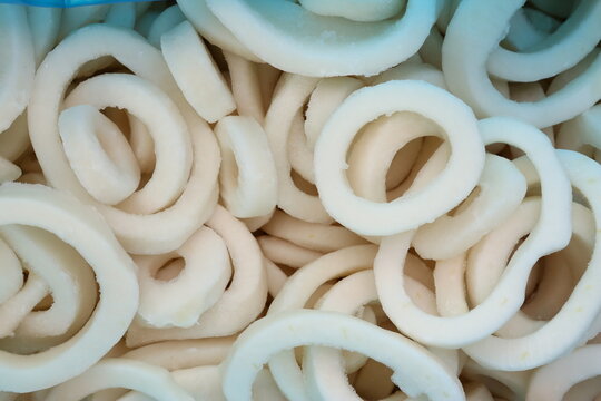 frosted squid body rings clos up photo on white table background