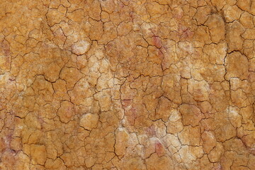 top view cracked  red soil ground Earth for texture background,desert cracks,Dry Orange surface...