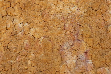 top view cracked  red soil ground Earth for texture background,desert cracks,Dry Orange surface...