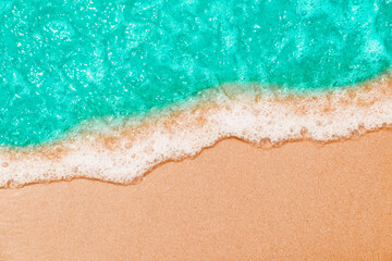 Soft Blue ocean wave on sandy beach. tropical white sand With the sea at the corner. - obrazy, fototapety, plakaty