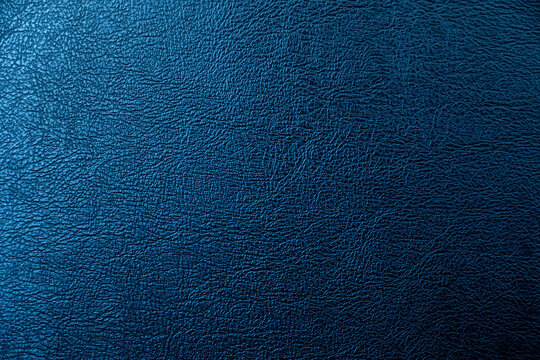 The surface of the black leather is Dark shaded by blue light.  Embossed pattern for luxury decoration or input text.