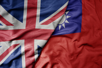 big waving national colorful flag of great britain and national flag of taiwan .