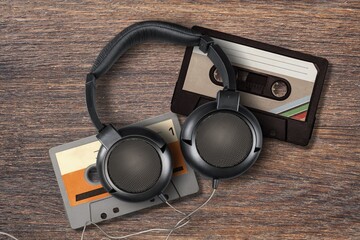 Vintage retro audio cassette and headphones on desk
