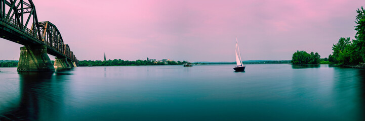 Tranquil Sunset Seascape with Fredericton Railway Bridge over St John River Recreation Park in New Brunswick, Canada