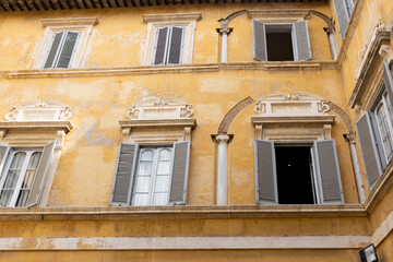 Architecture of Rome. A building with the characteristic facade and windows. Summer time
