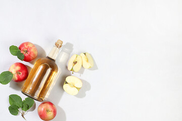 Apple cider drink, juice or fermented fruit drink and ingredients on a sunny table. Autumn banner. The concept of diet and weight loss. Healthy eating, body detoxification,