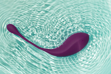 Washing in water of a vibrating vaginal and anal massager Egg - obrazy, fototapety, plakaty