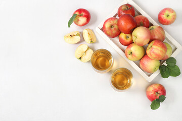 Apple cider, juice or fruit drink and ingredients on a sunny table. The concept of diet and weight...