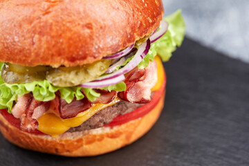 tasty burger with beef cutlet and vegetables