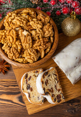 Christmas stollen on wooden background. Traditional Christmas festive pastry dessert. Holiday concept. Dessert, cake, pie with marzipan, nuts and dried fruits. Stollen for Christmas. Spicy pastries.
