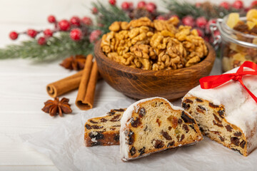 Fototapeta na wymiar Christmas stollen on wooden background. Traditional Christmas festive pastry dessert. Holiday concept. Dessert, cake, pie with marzipan, nuts and dried fruits. Stollen for Christmas. Spicy pastries.