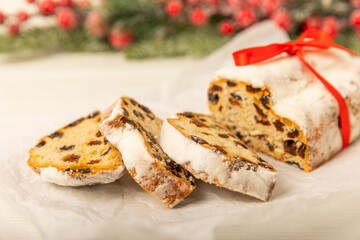 Christmas stollen on wooden background. Traditional Christmas festive pastry dessert. Holiday concept. Dessert, cake, pie with marzipan, nuts and dried fruits. Stollen for Christmas. Spicy pastries.