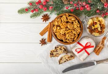 Christmas stollen on wooden background. Traditional Christmas festive pastry dessert. Holiday concept. Dessert, cake, pie with marzipan, nuts and dried fruits. Stollen for Christmas. Spicy pastries.