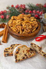 Christmas stollen on wooden background. Traditional Christmas festive pastry dessert. Holiday concept. Dessert, cake, pie with marzipan, nuts and dried fruits. Stollen for Christmas. Spicy pastries.