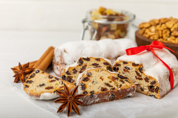 Christmas stollen on wooden background. Traditional Christmas festive pastry dessert. Holiday concept. Dessert, cake, pie with marzipan, nuts and dried fruits. Stollen for Christmas. Spicy pastries.