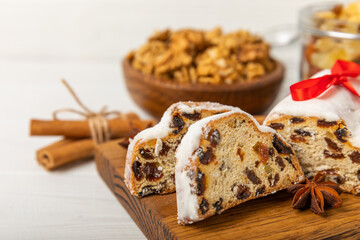 Christmas stollen on wooden background. Traditional Christmas festive pastry dessert. Holiday concept. Dessert, cake, pie with marzipan, nuts and dried fruits. Stollen for Christmas. Spicy pastries.