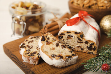 Christmas stollen on wooden background. Traditional Christmas festive pastry dessert. Holiday concept. Dessert, cake, pie with marzipan, nuts and dried fruits. Stollen for Christmas. Spicy pastries.