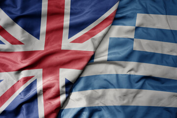 big waving national colorful flag of great britain and national flag of greece .