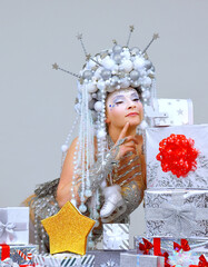 A Fantasy Snow Queen Is Surrounded By Christmas Gifts