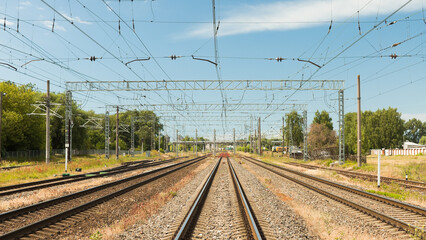 railway, in the photo rails against the background of a blue sky and clouds