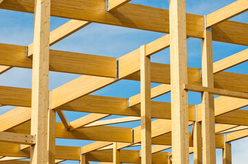 construction of a building made of wood in the background blue sky