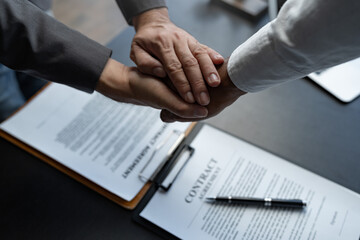 The handshake after a good cooperation, consulting between attorney and client, businessman, tax and real estate project company.