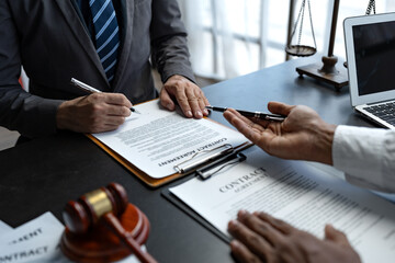 Attorneys or lawyer reading statute of limitations, consulting between male lawyers and business clients, tax firms and examining contract documents in business before signing