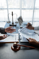 Attorneys or lawyer reading statute of limitations, consulting between male lawyers and business...