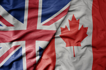 big waving national colorful flag of great britain and national flag of canada .