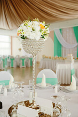 Wedding table with favors and flowers. Elegance wedding decor.