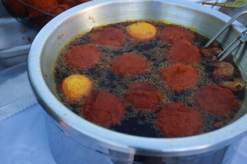 salvador, bahia, brazil - jule 15, 2023: frying acaraje in palm oil in the city of Salvador.