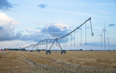 irrigation system with wind turbine in the farmland in Netherlands