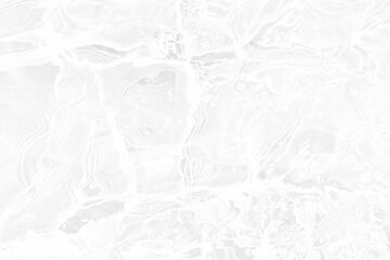 White water with ripples on the surface. Defocus blurred transparent white colored clear calm water surface texture with splashes and bubbles. Water waves with shining pattern texture background.