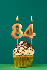 Birthday candle number 84 - Vertical anniversary card with green background