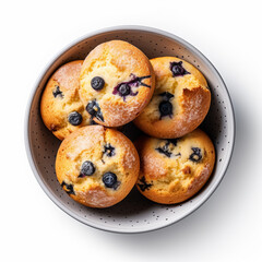 Top-down view of a bowl of blueberry muffins isolated on a white background