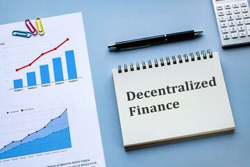 There is notebook with the word Decentralized Finance. It is as an eye-catching image.