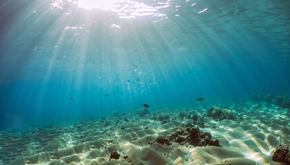 Underwater shot with sunrays in deep tropical sea
