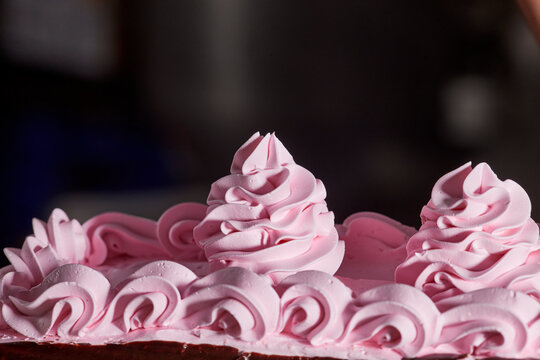 Detail strawberry icing flower accents on chocolate layer cake