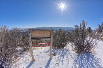 A humorous sign on Picnic Hill along the Thumb Butte day use hiking trail in the Prescott National Forest in winter referring to the city of Prescott as Who-Ville.