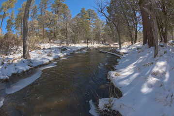 Miller Creek flowing through the Thumb Butte Recreation Area in the Prescott National Forest just west of Prescott Arizona, covered in winter snow and ice.