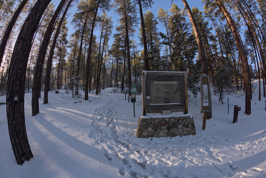 The Thumb Butte Recreation Area trailhead in the Prescott National Forest just west of Prescott Arizona, covered in winter snow and ice.
