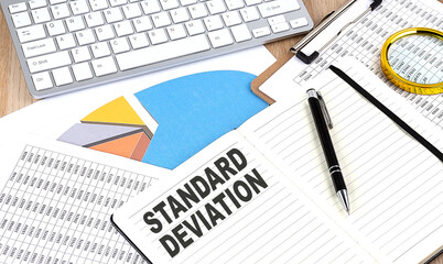 STANDARD DEVIATION text on notebook with chart and keyboard