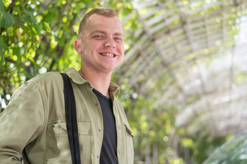 Happy caucasian man with hearing aids outdoors.