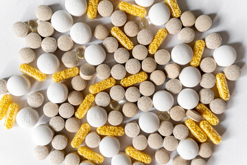 Different pills vitamins on the white table.  Medical, vitamins, health background